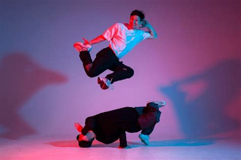 Premium Photo Two Dancer Guys Break Dance On Red Blue Background And