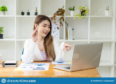 Asian Female Accountant Or Banker Calculating Savings Finance And Economy Concepts Via Laptop
