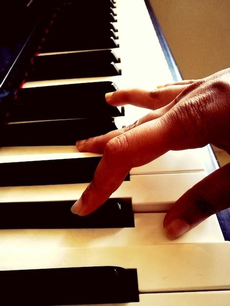 Premium Photo Cropped Hand Playing Piano