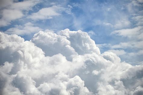 Dramatic Cumulus Clouds With High Level Cirrocumulus Clouds For