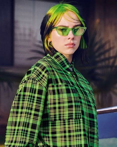 A Woman With Bright Green Hair And Sunglasses