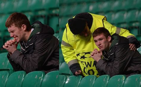 A barca fan outside the gates of camp nou crying while holding a messi jersey. A steward consoles a Celtic fan after Champions League ...