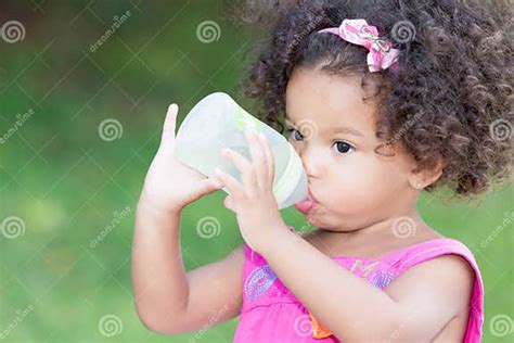 Cute Latin Girl Drinking From A Baby Bottle Stock Image Image Of