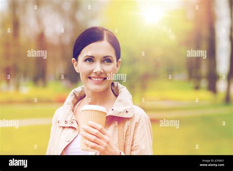 Smiling Woman Drinking Coffee In Park Stock Photo Alamy