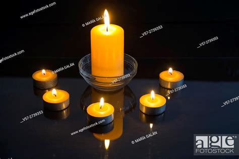 Lit Up Candles And Their Reflection On Glass Stock Photo Picture And