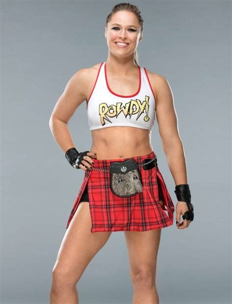 A Woman In A Red And Black Plaid Kilt Posing For The Camera With Her