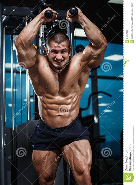 Strong Athletic Man Fitness Model Torso Showing Muscles In Gym Stock