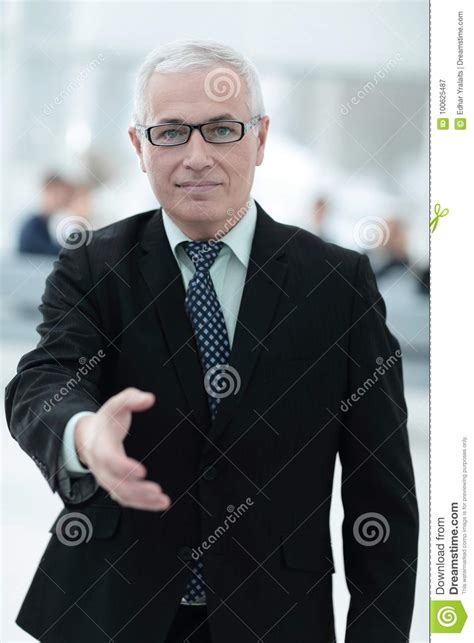 Closeup Of A Senior Businessman Offering His Hand For Greeting Stock