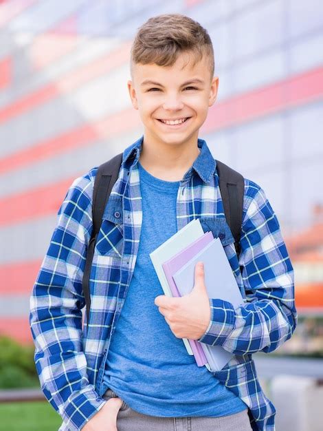 Premium Photo Happy Teen Boy Holding Books On The First School Day