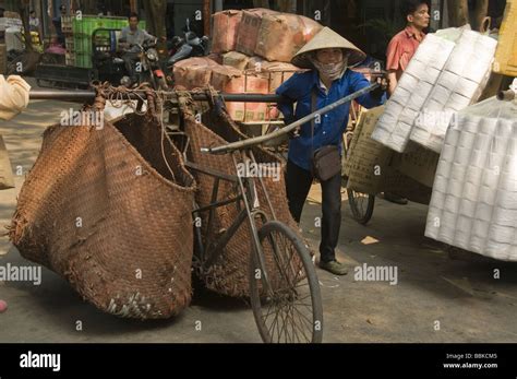 Vietnamese Workers Transporting Goods At The Border Crossing In Hekou