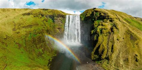 Famous Skogafoss Waterfall With A Rainbow Dramatic Scenery Of Iceland During Sunset Stock Image
