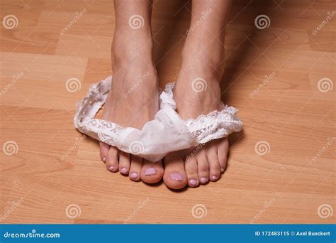 Close Up Feet Of Unrecognizable Woman With White Thong Panties Stock