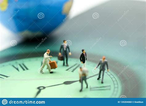 Miniature People Business Man Walking On The Clock Background Time