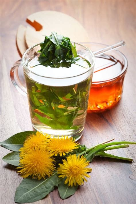 Herbal Tea With Dandelion Leaf In Tea Cup On Wooden Table Stock Photo