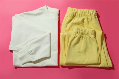 Premium Photo Folded Sweatshirt And Sweatpants On Pink Surface