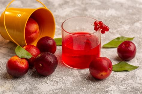 Free Photo Front View Fresh Sour Plums With Red Plum Juice Desk