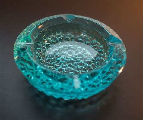 A Blue Glass Bowl Sitting On Top Of A Table