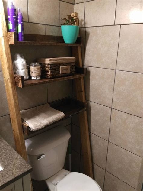 Take a ladder shelf and left out the bottom 2 rows to fit perfectly over the toilet. Leaning Bathroom Ladder Shelf | Ana White