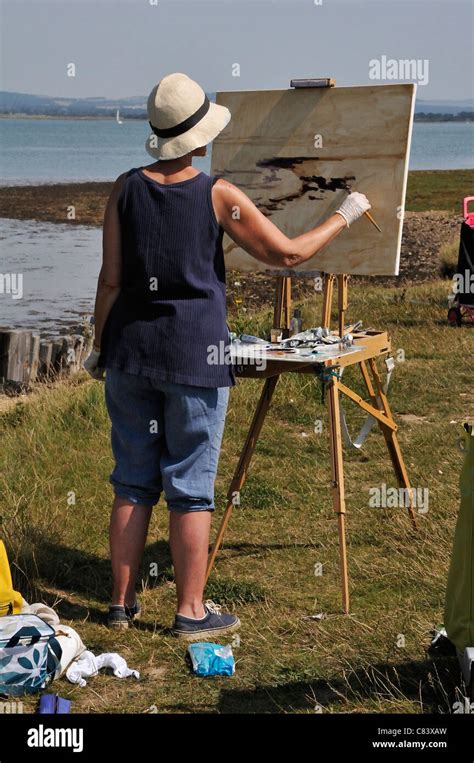 Female Artist Standing And Painting With Oils At Easel At Eleanor Point