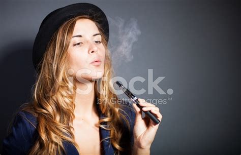 Elegant Woman Smoking E Cigarette With Smoke Wearing Suit And Ha Stock