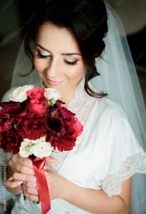 brunette bride smells red wedding bouquet stock foto adobe stock