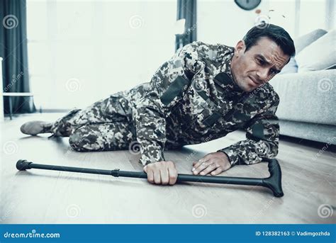Handicapped Military Lying On Floor With Crutch Stock Image Image Of
