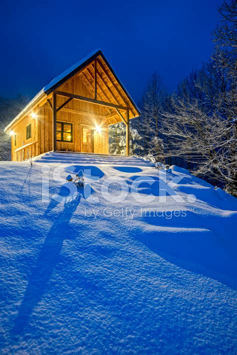 Rustic Cabin In Winter Blizzard Snowstorm At Night Stock
