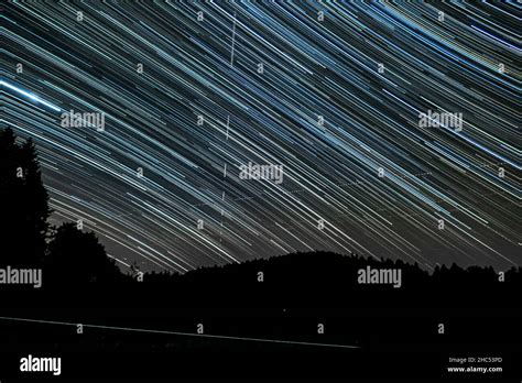 Scenic View Of The Sky Covered In Star Trails During The Night Stock