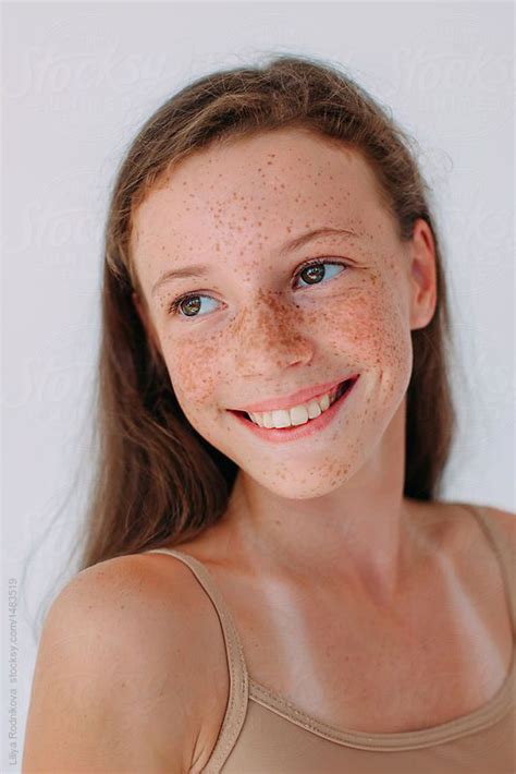 Closeup Portrait Of Extremely Beautiful Happy Smiling Girl With Freckles Posing On White