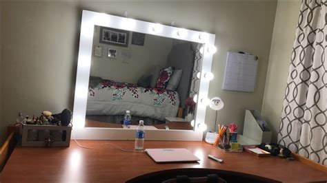 A Desk With A Mirror And Lights On It