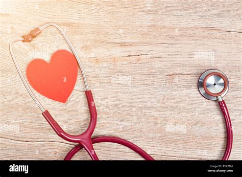 Stethoscope Medical With Red Heart On Wooden Background With Free Space