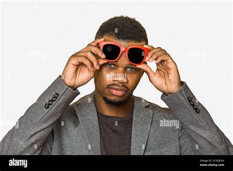 Confident Black Man In Smart Casual Outfit Lifting Stylish Sunglasses