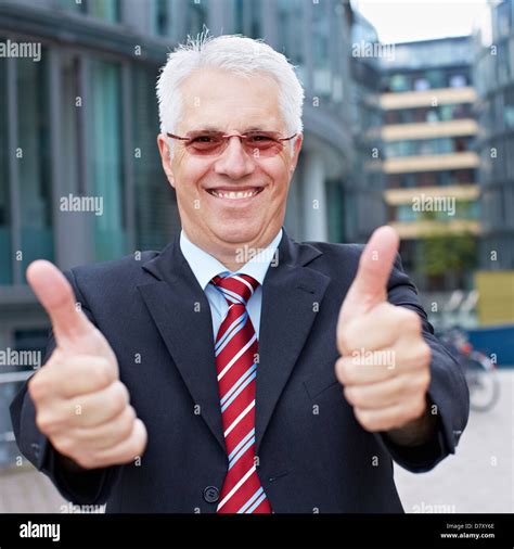 Happy Senior Business Man Holding His Thumbs Up Outside The Office
