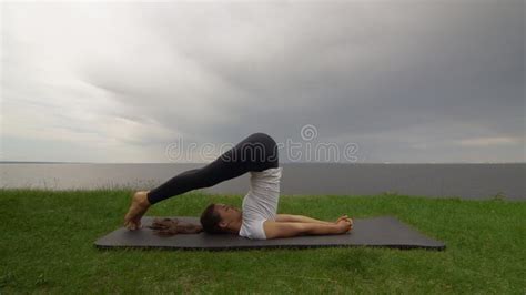 Young Fit Woman Practice Yoga On Coast Near The Lake Or Sea Woman