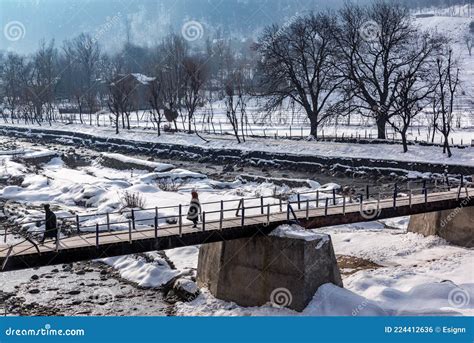 Kashmiri Villagers Crossing The River With A Bridge Built On The