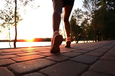Runner Feet Running On Road Closeup On Shoe Outdoor At Sunset Or