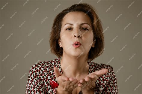 premium photo portrait of a woman blowing a kiss