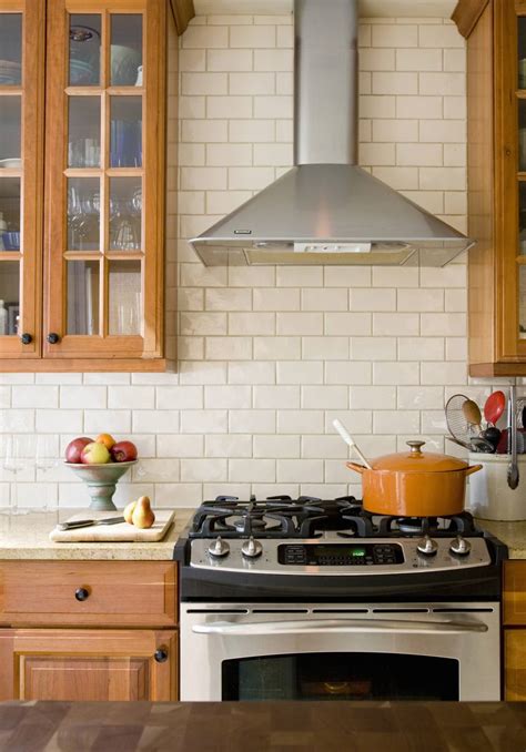 Just a like a beautifully painted feature wall in any other room of a home, the area above the cooktop. Kitchen Tile Backsplash Tips - Working Around Obstacles