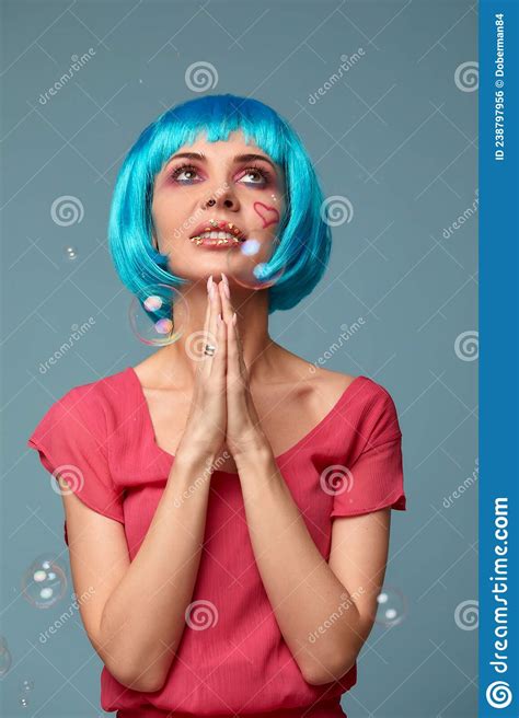 Beautiful Young Woman With Blue Wig And Bright Make Up In Soap Bubbles