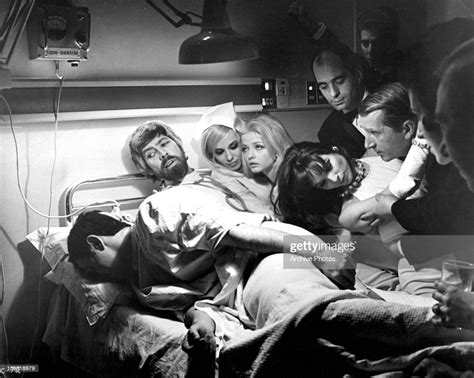 James Coburn Ewa Aulin And Others Crowd On And Around A Hospital Bed