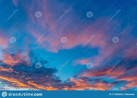 Beautiful Shot Of Pink Clouds In A Clear Blue Sky With A Scenery Of