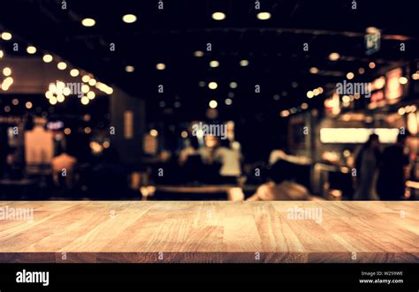 Wood Table Top Bar With Blur Light Bokeh In Dark Night Cafe