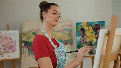 Young Happy Artist With Paintbrush In Hands Posing On Camera While