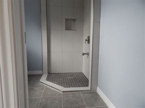 The wall can be installed with larger tiles in order to make the tiling procedure a lot faster. Tiled Corner Shower - creativetilingsolutions