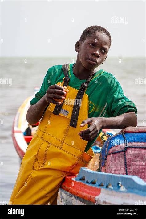 Portrait Of A Young Fisherman Casually Leaning Against His Colourful