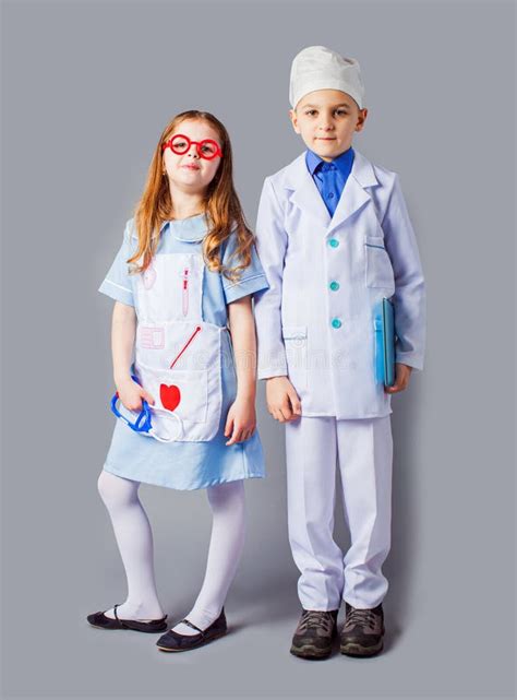 Cute Boy And Girl In Medical Uniform Playing Like Doctors Stock Image