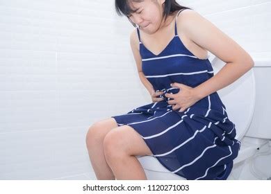 Woman Sitting On Toilet Diarrhea Constipated Stockfoto 1120271003
