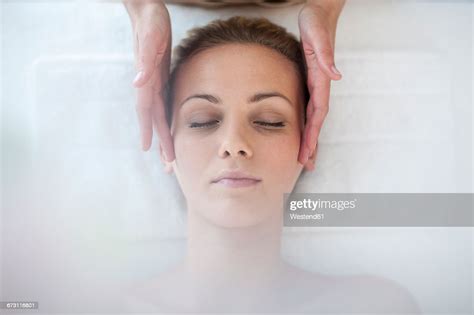 Young Woman Lying On Massage Table Receiving Beauty Treatment Photo