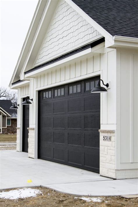 Poplar tongue and groove stained as stated before, the modern farmhouse style is all about functionality. Garage Doors. Vertical Siding. Black Lamps. | Modern ...