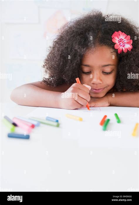 Mixed Race Girl Drawing With Crayons Stock Photo Alamy